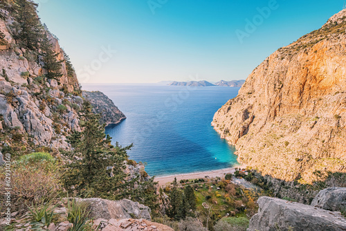 Butterfly valley verdant cliffs form a natural amphitheater, framing the azure waters and creating a postcard-perfect scene in Lycian Way Turkiye