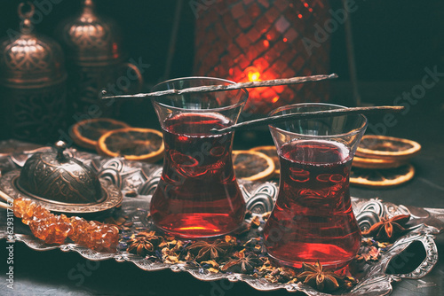 Cups of turkish tea served in traditional style with spices