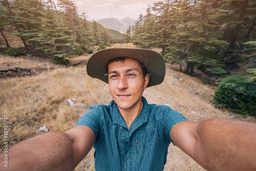 Fotografi Happy man traveler naturalist against the backdrop of a Lycian way in the woods
