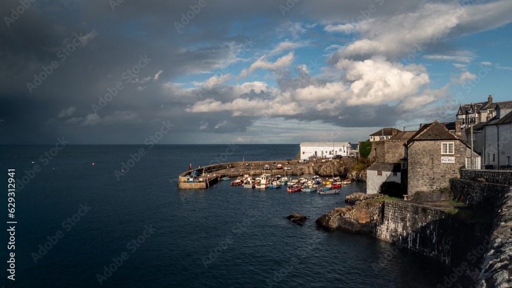 Coverack harbour landscape with rainbow and stormy skies
