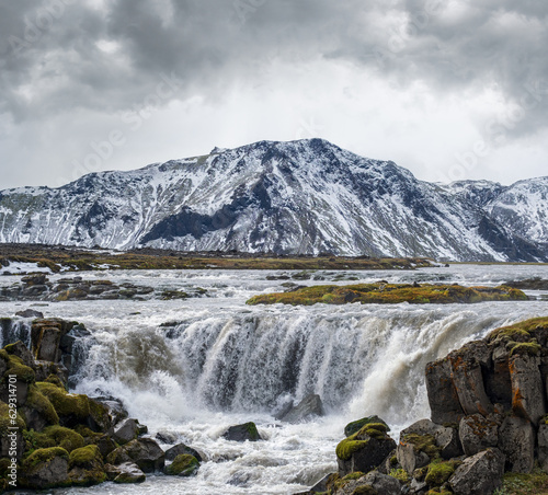 Picturesque waterfal Tungnaarfellsfoss  Iceland  panoramic autumn view  Landmannalaugar mountains under snow cover in far.