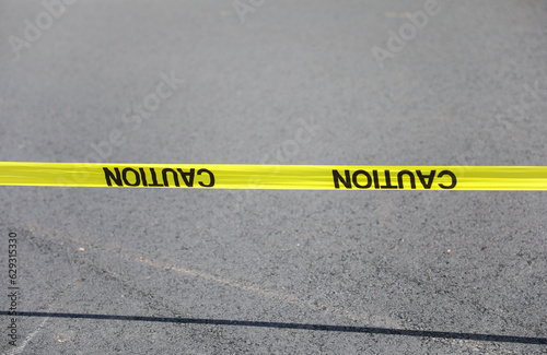 yellow caution tape signals danger and restriction. Its bright color symbolizes warning and attention. A visual cue to stay safe and avoid potential hazards photo