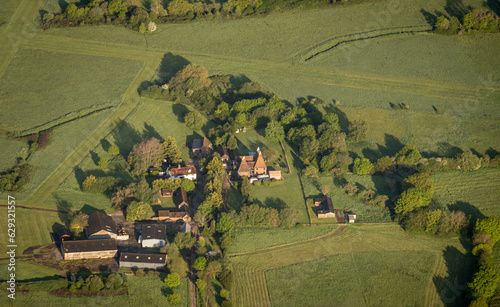 Aerial view of a farm with oast houses in the countryside in Kent, UK photo