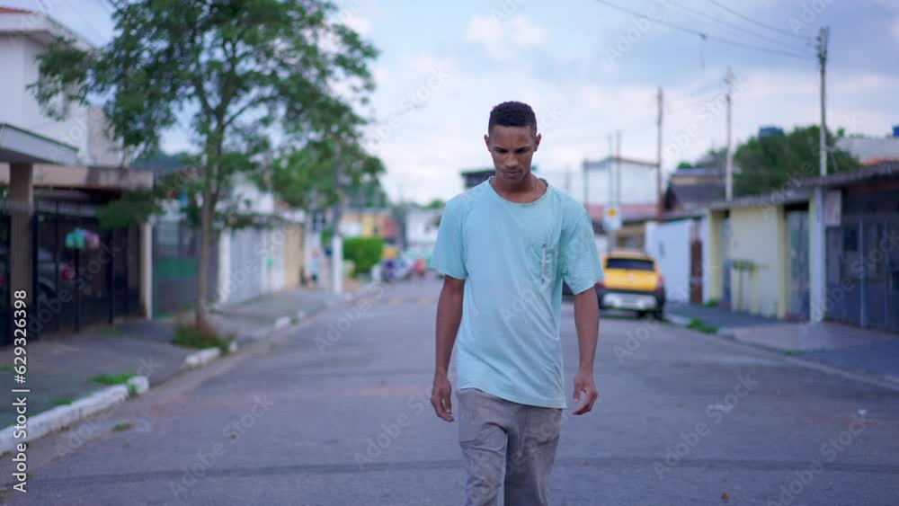 One Black Brazilian Man Walking on Street with contemplative thoughtful expression, Deeply Pondering a Difficult Decision One Black Brazilian Man Walking on Street with contemplative thoughtful expression, Deeply Pondering a Difficult Decision