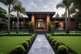 The exterior of the house is visually appealing, catching the eye from the curb. The lush green lawn is accompanied by a layer of brown sawdust, adding texture and aesthetic appeal. In addition, there