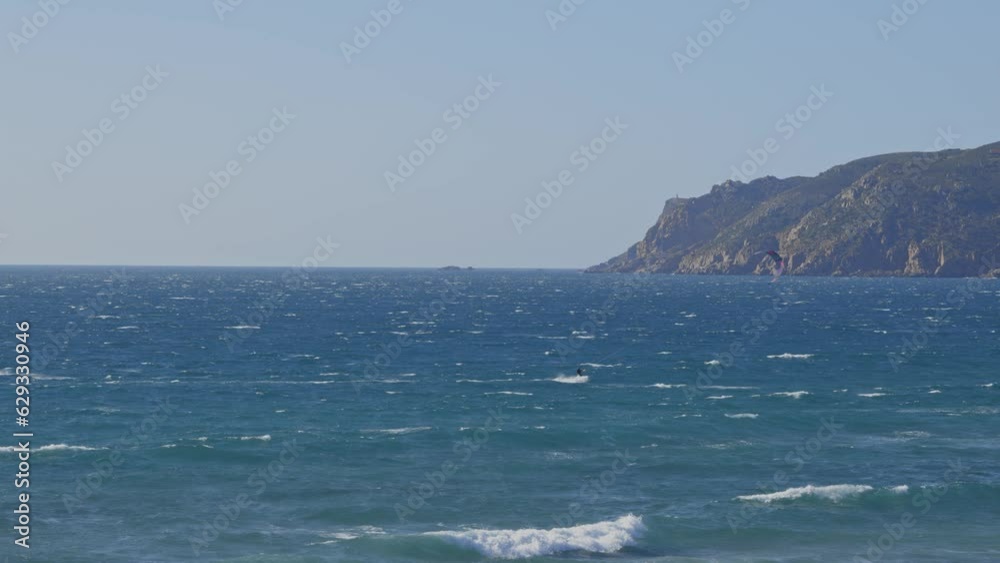 People are kitesurfing in the blue ocean People are kitesurfing in the blue ocean