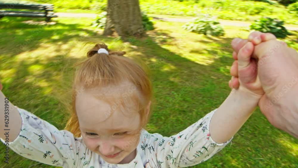 POV of dad spinning daughter in park. Father playing with young child. Carefree family enjoying weekend. Happy childhood. Cute kid. Close-up in 4K, UHD POV of dad spinning daughter in park. Father playing with young child. Carefree family enjoying weekend. Happy childhood. Cute kid. Close-up in 4K, UHD