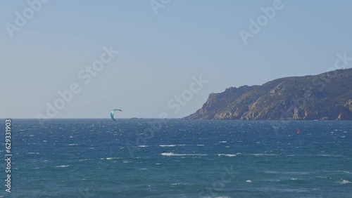 A man kitesurfing in the blue ocean - beautiful landscape