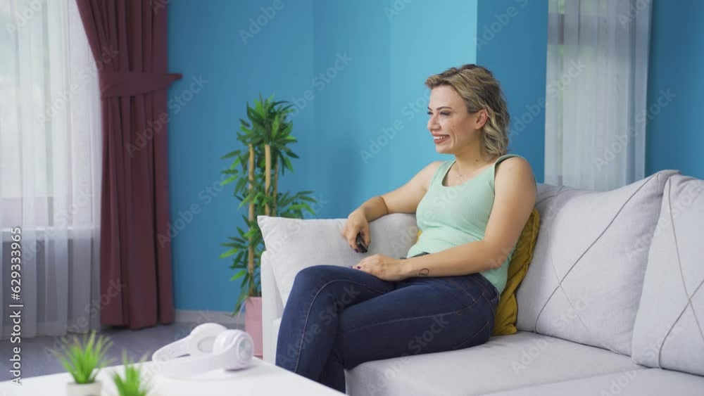The woman watching television rejoices. The woman watching television rejoices.
