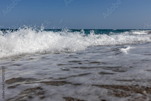 a white waves in the blue sea on the beach © vovan