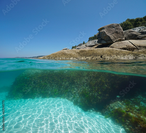 Boulders on the sea shore, split view over and under water surface, Atlantic coast in Spain, natural scene, Galicia, Rias Baixas
