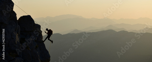 Young Man Doing Tough Rock Climbing

