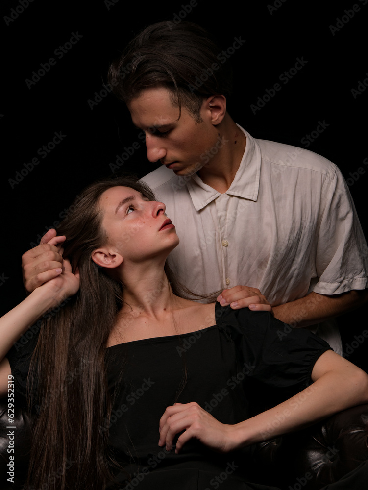 young couple white brunette man and white brunette woman with long hair on a dark background young couple white brunette man and white brunette woman with long hair on a dark background