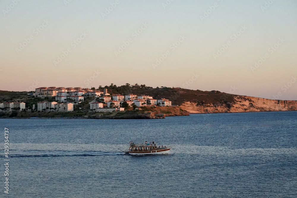 Fototapeta premium sunset with tour ship foça