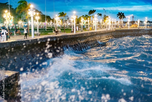 Tidal waves along Rizal Boulevard at dusk, Dumaguete waterfront,Negros Island,Philippines. photo