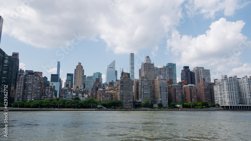 View of Manhattan midtown across the East River with billionaire s row skyscrapers visible in the background.
