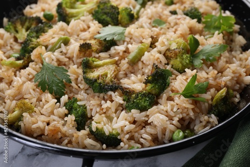 Tasty fried rice with vegetables on table, closeup