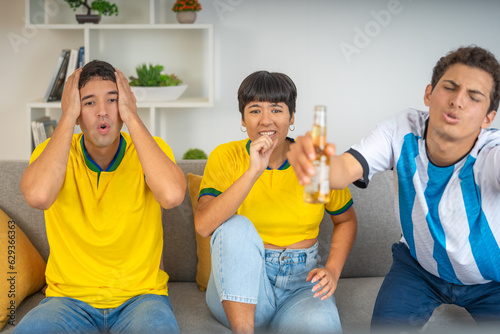 Group of friends watching a soccer game and drinking beer