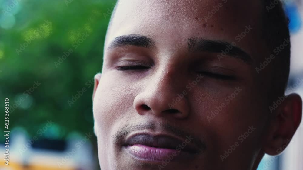 Religious Brazilian young man close-up face closing eyes and gazing upwards in Spiritual contemplation Religious Brazilian young man close-up face closing eyes and gazing upwards in Spiritual contemplation