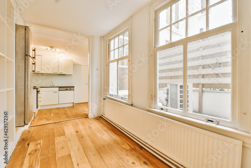 an empty living room with wood flooring and white walls in the room is very large  bright window view