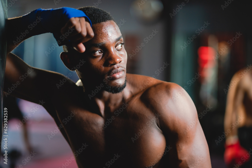 Young muscular african american male boxer looking at camera, wearing boxing gloves, standing isolated over grey background. Sports, workout and bodybuilding concept, confident african american boxer Young muscular african american male boxer looking at camera, wearing boxing gloves, standing isolated over grey background. Sports, workout and bodybuilding concept, confident african american boxer