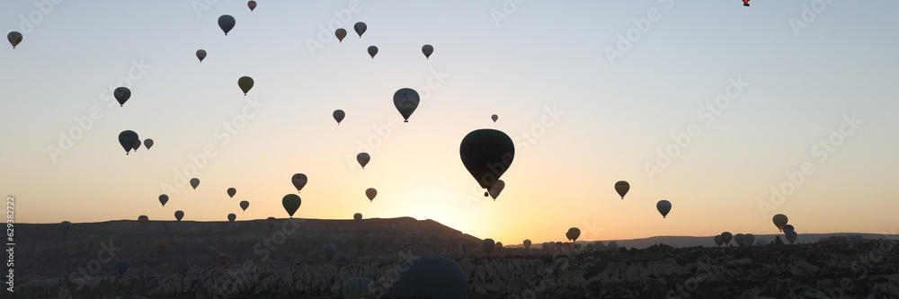 Many hot air balloons flying in sunset sky at Cappadocia, Turkey. Many hot air balloons flying in sunset sky at Cappadocia, Turkey.