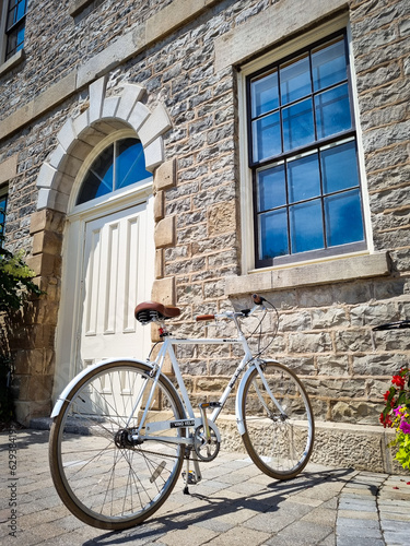 Vintage Charm: White Bicycle by an Antique Building