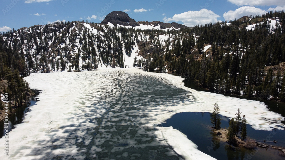 Kinney reservoir surface partially frozen with Ebbetts peak in the background