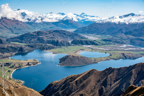 Stunning scenic views of the bays of Lake Wanaka and the snow capped Southern Alps from the Roys Peak mountain track