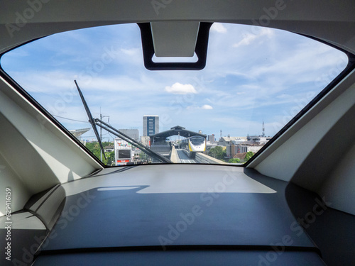 Bangkok, Thailand - June 4, 2023: A view from the windshield shows another Thailand's first driverless elevated monorail passing by