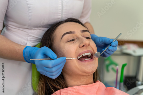 dentist doing examining for cavities or gum disease with medical tools