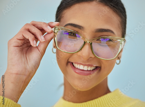 Woman portrait, glasses and vision with blue light frame with a smile with ophthalmology. Isolated, studio background and happy person with eye care, wellness and health of a girl with eyewear