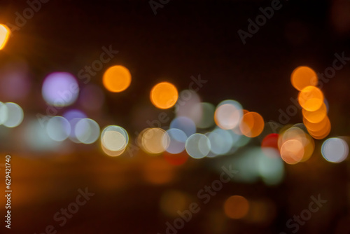 bokeh background of the shop lamps and street  light in the night out of focus © Khanawut