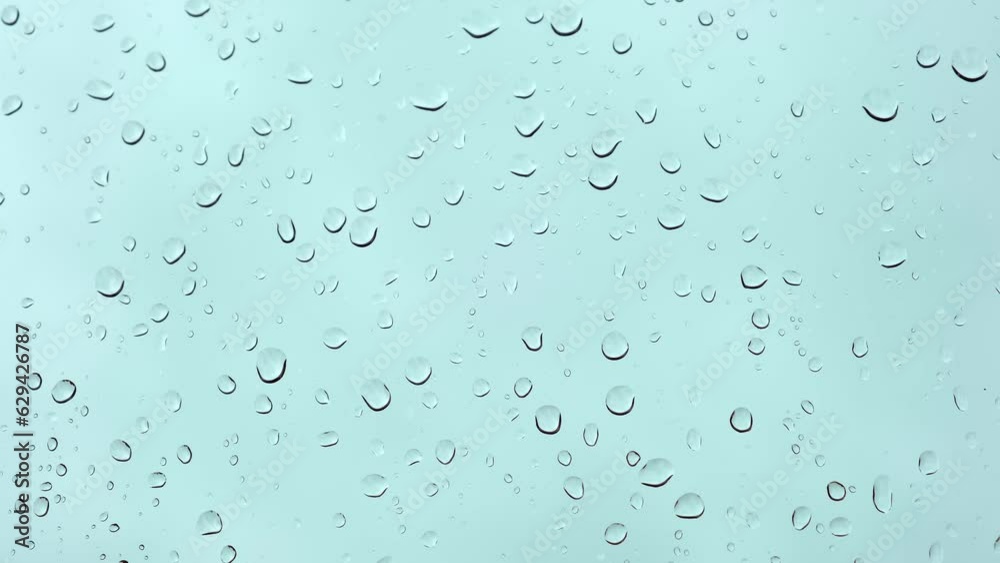 Raindrops flow down by the window glass. Rainy weather. Gray cloudy sky background. Sad depressed mood. Nature cry concept. Autumn weather detail. Wet and cold season. Abstract texture. Grey texture. Raindrops flow down by the window glass. Rainy weather. Gray cloudy sky background. Sad depressed mood. Nature cry concept. Autumn weather detail. Wet and cold season. Abstract texture. Grey texture.