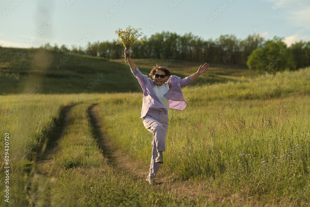 Senior woman, at ease in nature with wildflowers, showcasing the tranquility achievable with secure financial planning Senior woman, at ease in nature with wildflowers, showcasing the tranquility achievable with secure financial planning