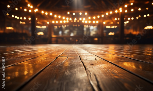 empty wooden stage floor under a wash of golden light