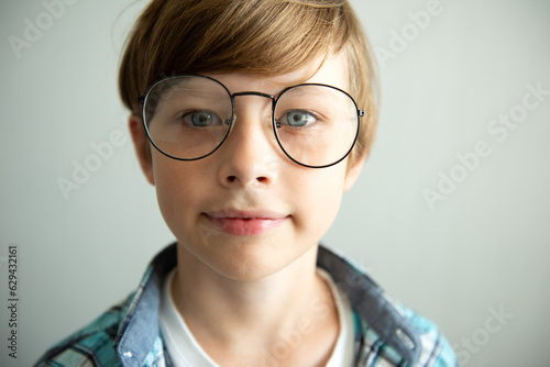 Teenager kid boy in myopia correction glasses