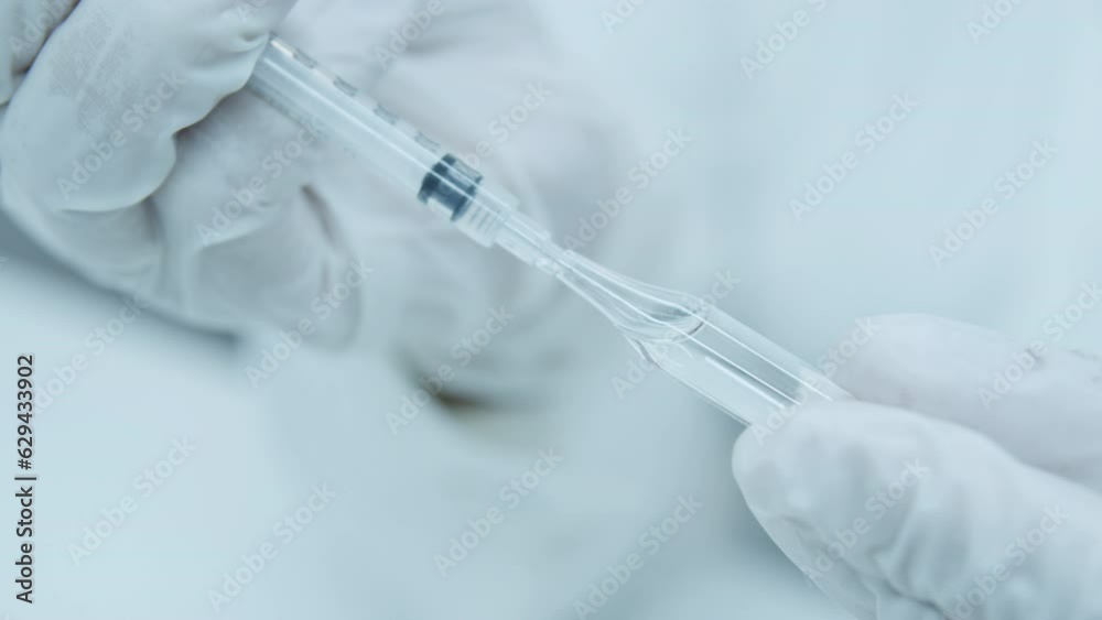 Close-up of a syringe and a glass jar of medicine. Vaccination. Disease vaccination. Virus prevention. Insulin syringe. The doctor opens the ampoule and prepares an injection. White medical gloves. Close-up of a syringe and a glass jar of medicine. Vaccination. Disease vaccination. Virus prevention. Insulin syringe. The doctor opens the ampoule and prepares an injection. White medical gloves.