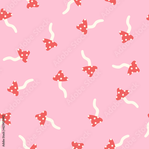 Fly agaric on a pink background seamless pattern. 