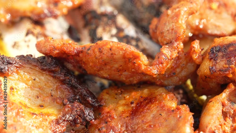 Close-up chicken meat with skin Roasted on grill rack, cooking outdoors daytime