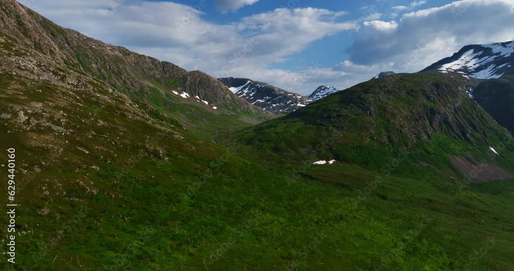 Drone shot flying in middle of mountains and arctic nature, summer in Troms, Norway Drone shot flying in middle of mountains and arctic nature, summer in Troms, Norway