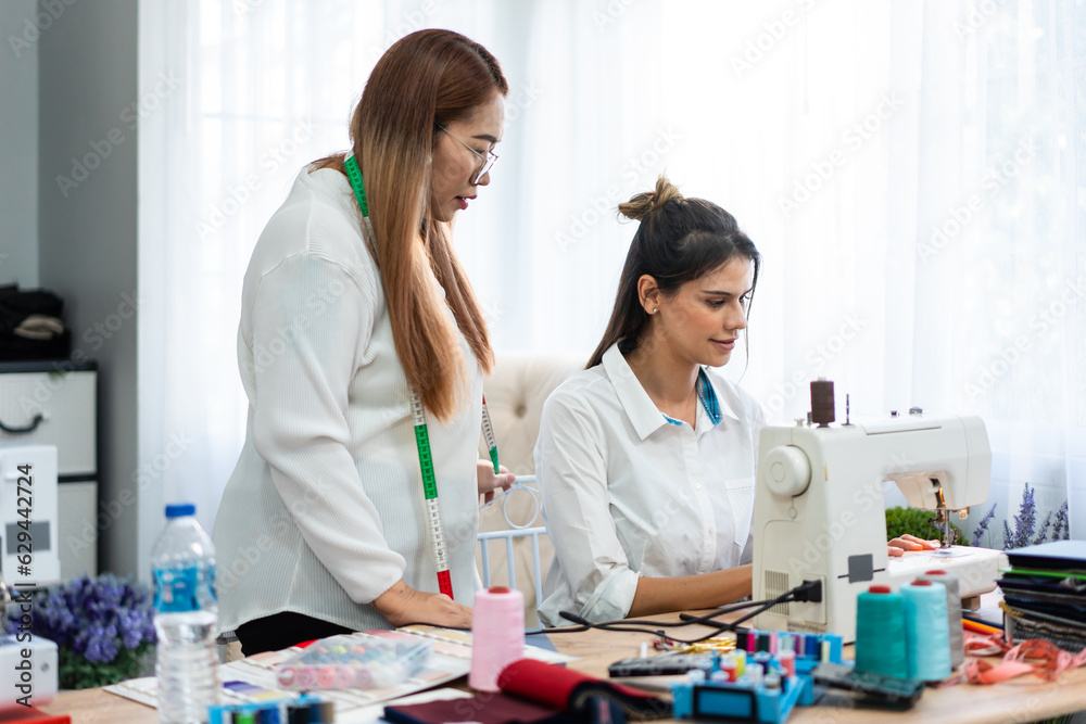 Diverse women fashion designer work design clothes in tailoring atelier. Diverse women fashion designer work design clothes in tailoring atelier.