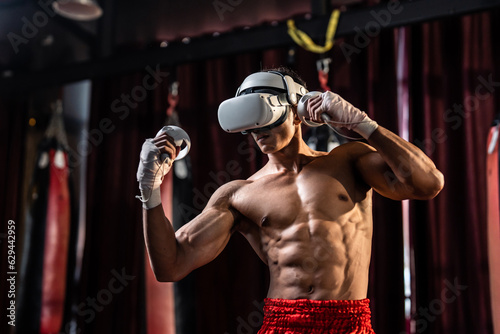 Asian sportsman using innovative technology VR glasses for exercise.  © Kawee