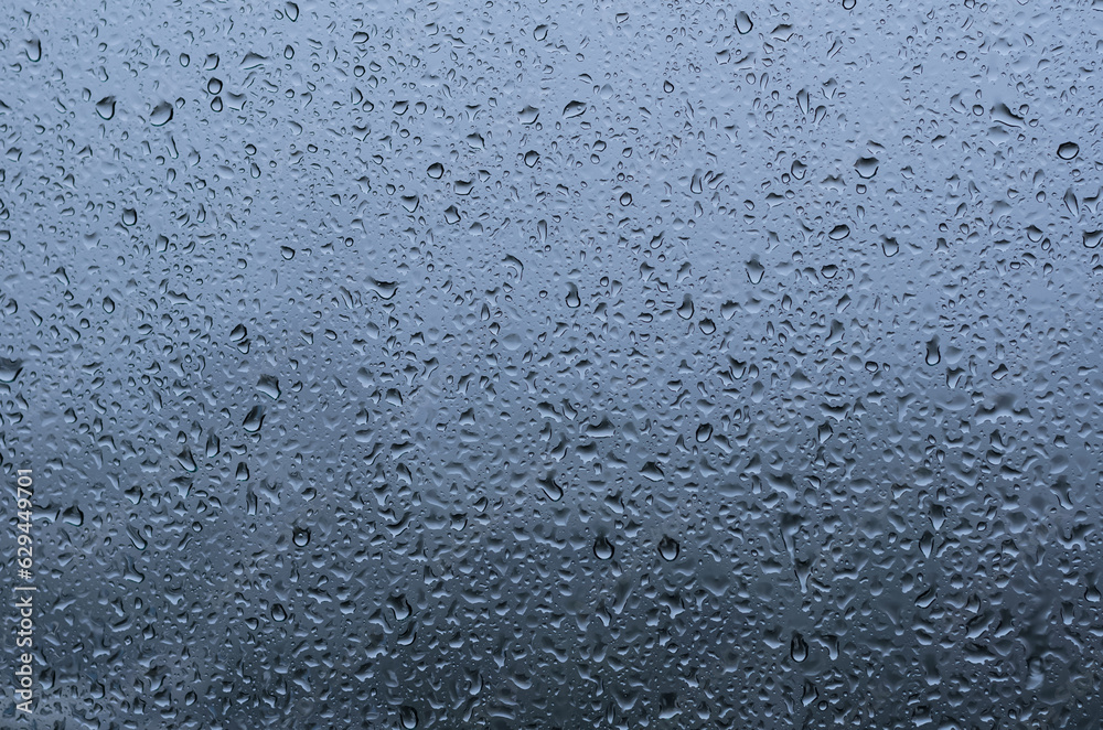 Rain drop on glass window with blue background in monsoon season. Rain drop on glass window with blue background in monsoon season.