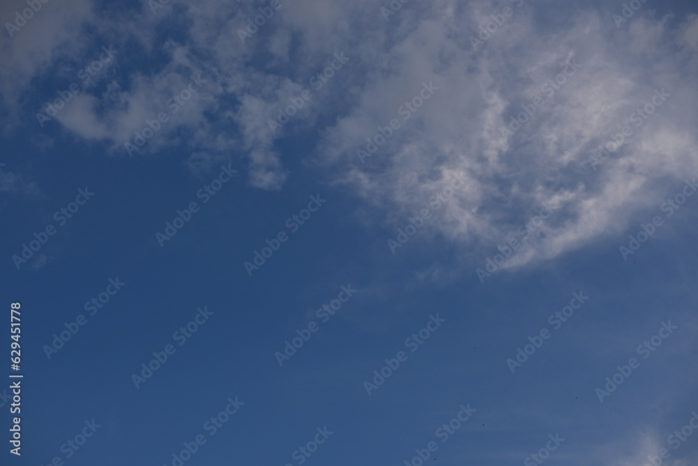 White clouds against the blue sky
background summer cloudy sky, soft light blue white sky background