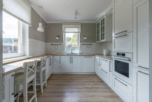 Stylish interior of a modern bright kitchen with a window, in a new house