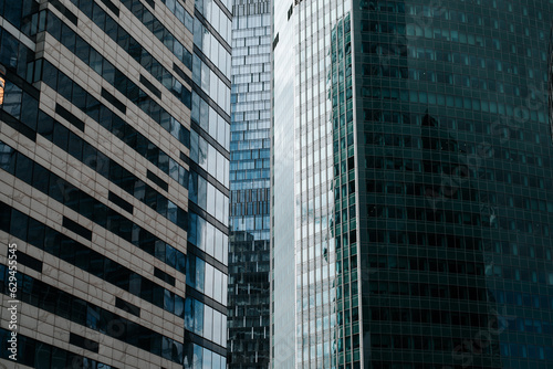 Front view of modern skyscrapers offices exterior, close-up of business district glass windows of building