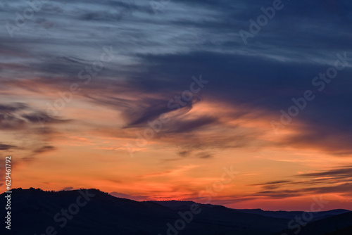 Sunset in the mountains, beautiful clouds. © Arkd