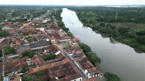 aerial of Santa Cruz de mompox Colombia colonial style little town village in Bolivar department drone above city center with church and river Magdalena photo