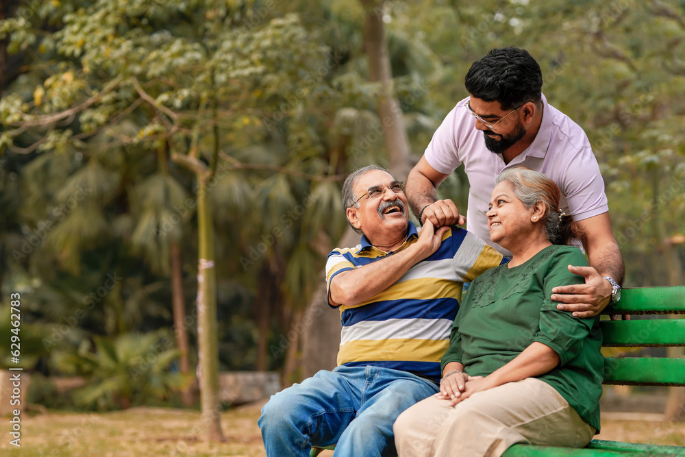 Young Indian man with his parents at park